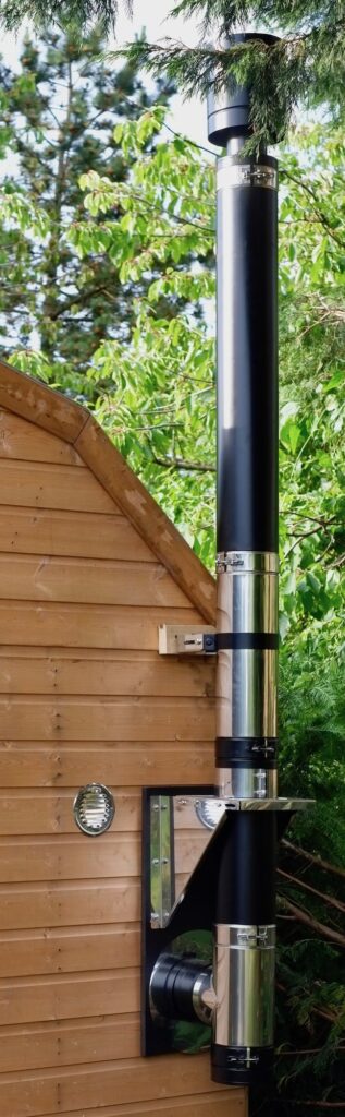 small stove installed in a shed wall exit